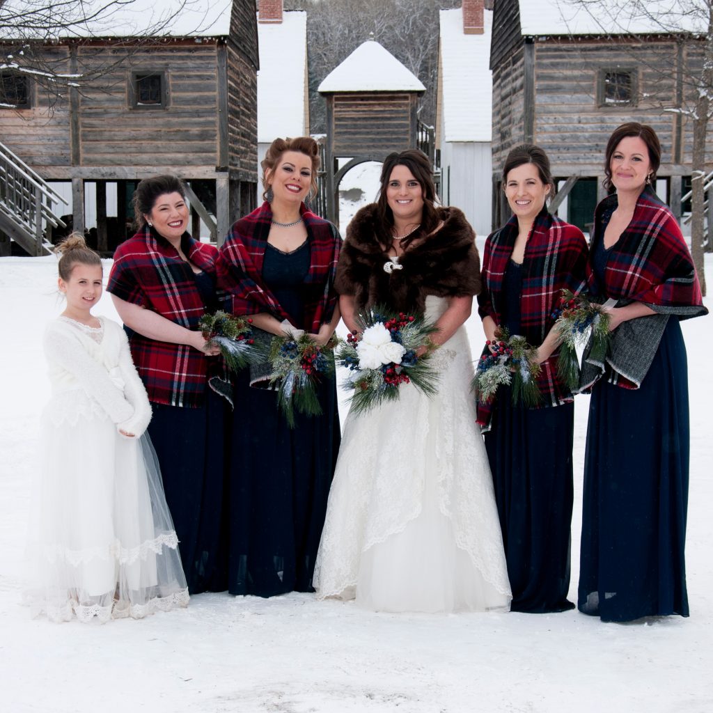 Female members of a wedding party in the main square in winter