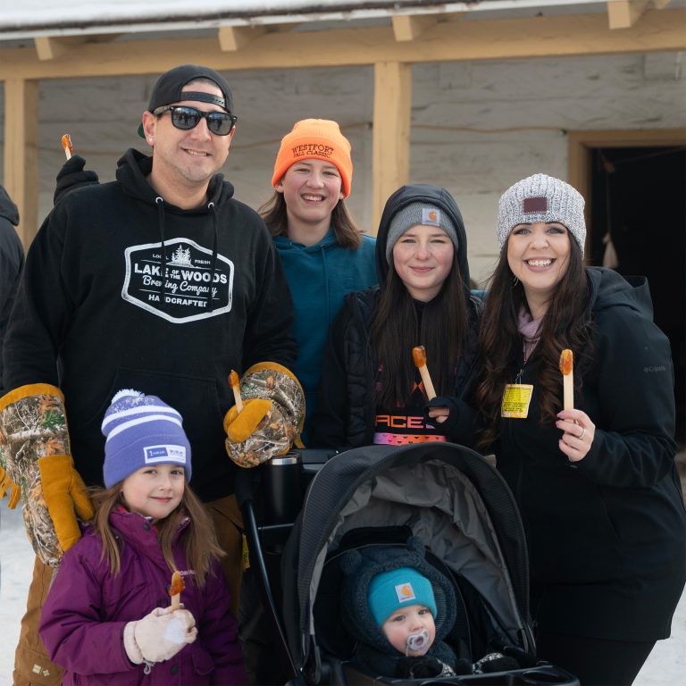 Smiling family at Voyageur Winter Carnival